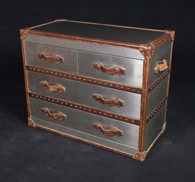 a metal chest with three drawers on top of it