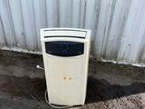 a white refrigerator sitting in front of a metal wall