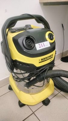 a yellow and black vacuum sitting on a tiled floor