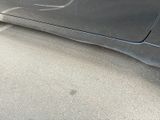 a black car parked on the side of the road
