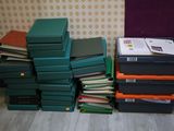 many books stacked on top of each other on the floor