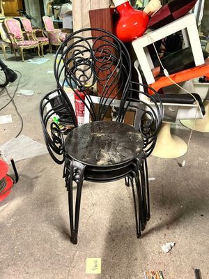 a chair that is sitting in the middle of a pile of junk