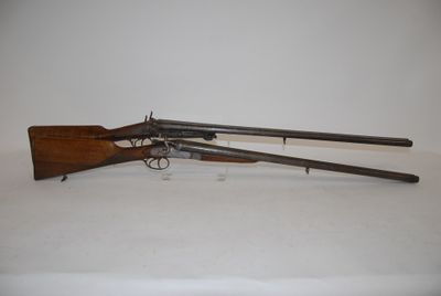 an old gun with two guns on a white surface
