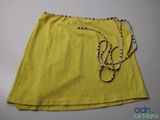 a close up of a yellow skirt on a white table