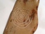 a picture of a stone with a spiral design on it