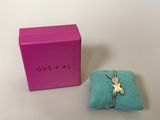 an image of a pink box with a blue pillow and a silver ring on it