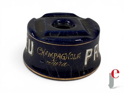 a black and gold cup on a white surface
