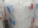 une pile de sacs en plastique posée sur des palettes dans un entrepôt