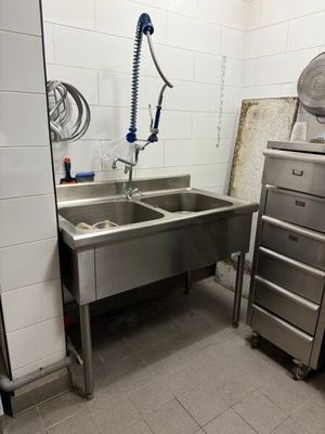 a kitchen with a sink and a refrigerator in it
