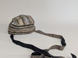 a hat that is laying on the ground with a ribbon