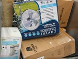 a box with a fan sitting on top of a pile of boxes
