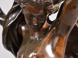 bronze statue of a woman holding a tray with a bird on it