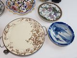 many plates and bowls sitting on a table together