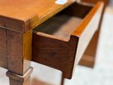 a small wooden table with a drawer on top of it
