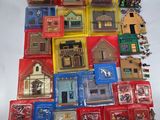 a lot of different types of miniature buildings on the table