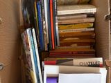 a cardboard box full of books on the floor