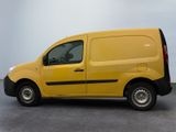 the yellow van is parked in a parking lot on a cloudy day
