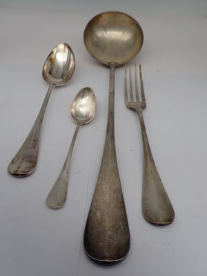 five silver spoons and two silver spoons on a white table