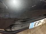 a close up of a black car with a number plate on it