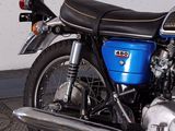 a blue motorcycle that is parked in a garage