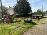 a pile of bricks sitting on the grass in front of a house