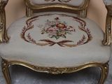 a chair that has a floral design on the back of it
