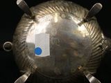 a silver object with a blue dot on it