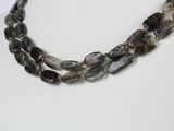 two strand necklace with grey and black beads on a white mannequin