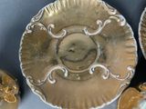 a gold plate with a picture of a face on it