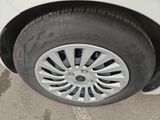 a close up of a tire on a white car