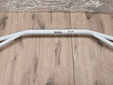 a close up of a white handle bar on a wooden floor