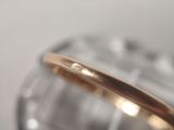 a close up of a gold ring on a clear plate