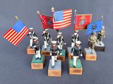 several figurines of military men holding flags and standing on pedestals