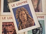 four books on a table with pictures of statues on them