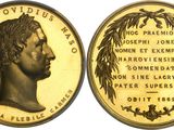 a close up of a gold coin with a woman ' s face