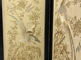 two framed pictures of birds and flowers in a room