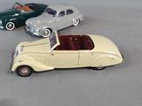several toy cars are lined up in a row on a gray surface