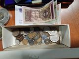 a box full of coins sitting on a table