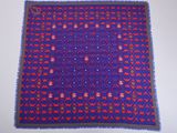 a blue and red rug with red and purple designs on it