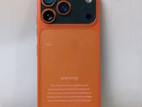 a close up of an orange iphone case on a white surface
