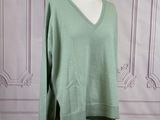 green v - neck sweater on a mannequin base