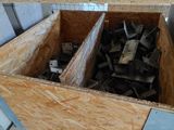 a wooden box filled with metal pieces in a room