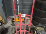 a pile of tires and a hand truck in a garage