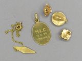 a close up of a gold plated necklace and other items on a table
