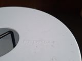 a close up of a white plate with a small hole in it