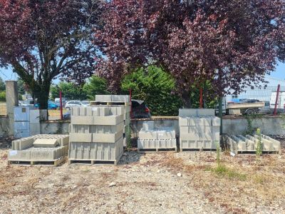 a pile of concrete blocks sitting on the ground in front of a tree