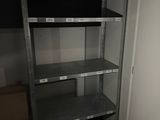 a metal shelving in the corner of a room