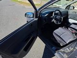a black car with its door open on the street
