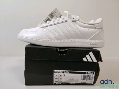 a pair of white shoes on top of a box