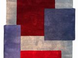 a red, blue and grey rug with squares on it